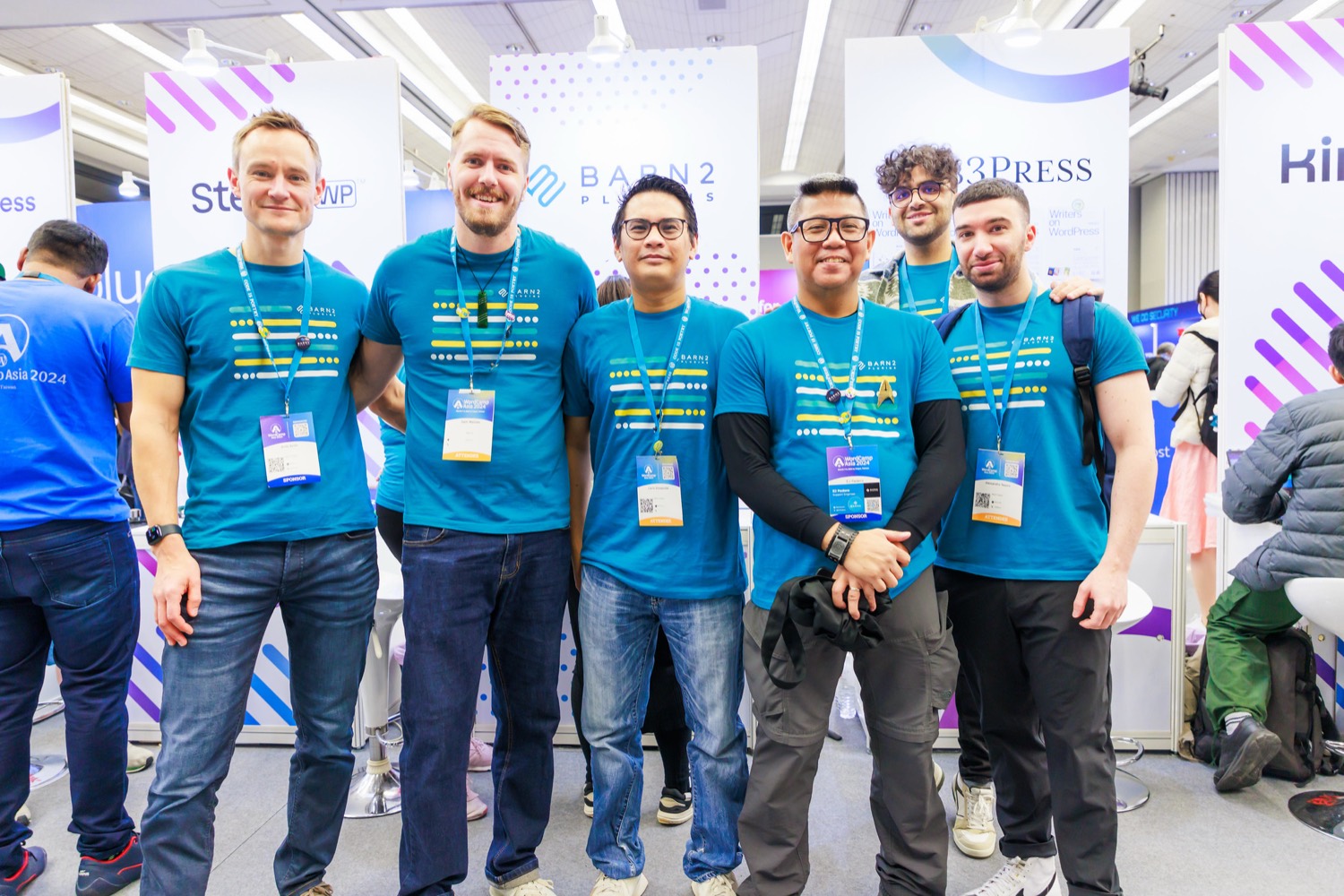 Members of the Barn2 team at their stand at a WordCamp