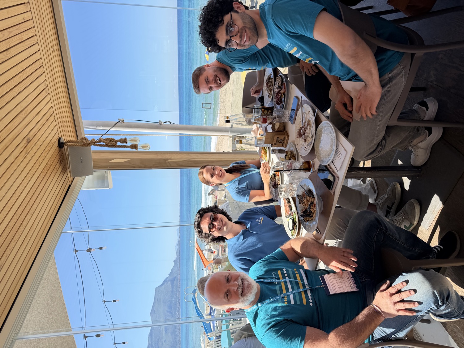 The Barn2 team having lunch together by the sea